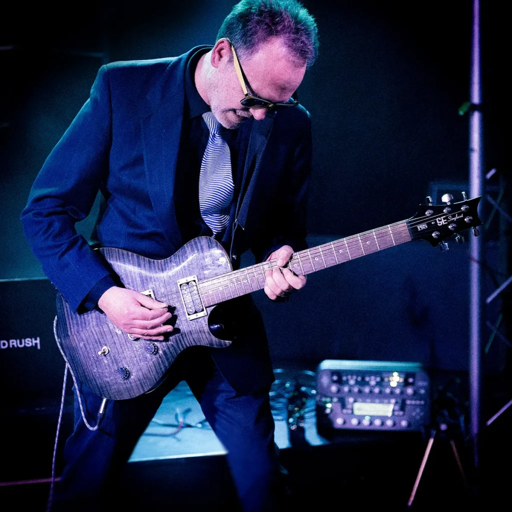 Steve Whitton playing guitar live on stage with The Expletives, Lincolnshire
